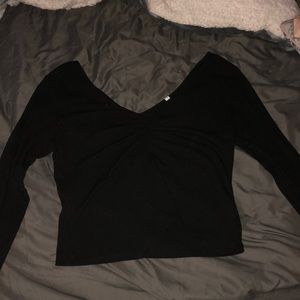 Black long sleeve shirt and low cut in the front